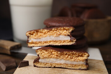 Tasty choco pies on coaster, closeup view