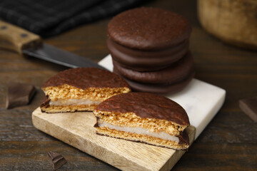 Tasty choco pies on wooden table, closeup