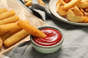 Delicious cheese sticks and ketchup on table, closeup