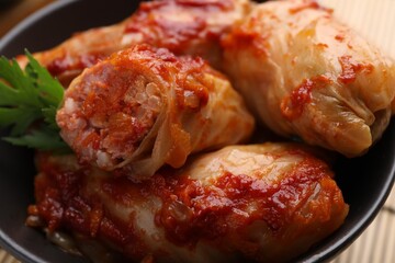 Delicious stuffed cabbage rolls cooked with homemade tomato sauce in bowl, closeup