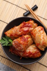 Delicious stuffed cabbage rolls cooked with homemade tomato sauce on table, top view