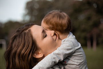 Mother embracing her young child toddler - 620521893