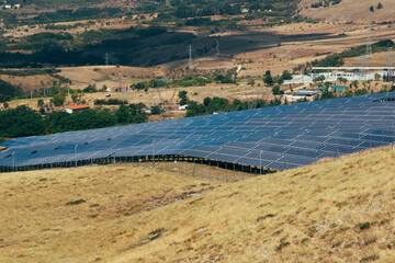 Fototapeta na wymiar Conceptual photo of eco-sustainable technologies and industry 2.0. A solar power plant with photovoltaic panels in the countryside in nature for clean energy against coal and fossils