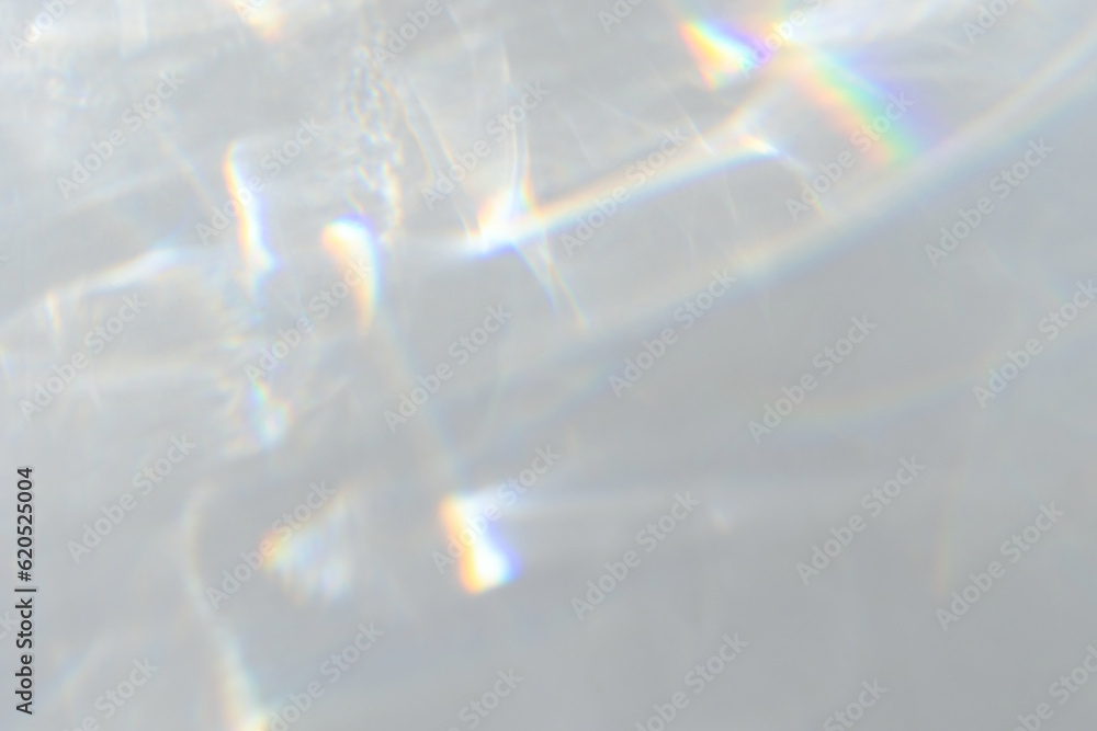 Wall mural crystal prism rainbow light refraction texture on white wall background. organic drop diagonal holog