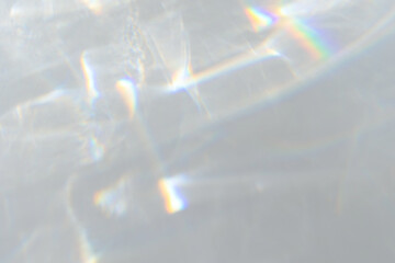  Crystal prism rainbow light refraction texture on white wall background. Organic drop diagonal holographic flare on a white wall. Water shadows for natural light overlay effects - 620525004