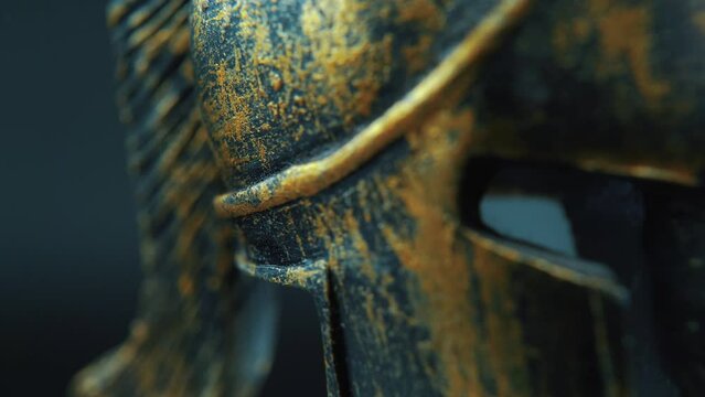 A close up macro cinematic shot of a spartan face design, warrior metal bronze helmet, on a 360 rotating stand, studio lighting, 4K slow movement