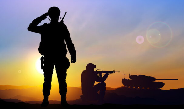 Silhouettes of a soliders with main battle tank against the sunset. EPS10 vector