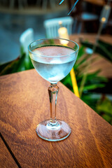Long stem glasses filled in with light blue drink cocktail. Bar and restaurant concept. 