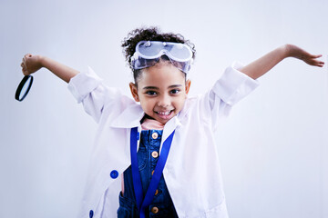 Child, happy and portrait of a scientist girl in studio with open hands, glasses and a magnifier. Face of a African kid student excited for medical science, education or biology experiment for future