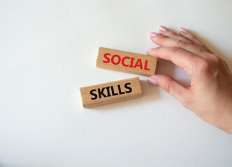 Social skills symbol. Wooden blocks with words Social skills Beautiful white background. Businessman hand. Business and Social skills concept. Copy space.