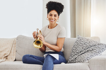 Portrait, woman and trumpet in home for music, learning and practice classic jazz song. Happy young...
