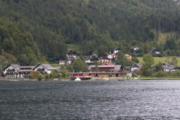 Fototapeta na wymiar lakeside House surrounded by mountains, Austria