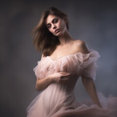 Portrait of beautiful young woman in pink dress on gray background. Studio shot. Portrait of a beautiful sensual young woman  in evening long dress. Beauty, fashion.