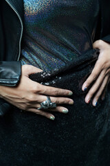 Black Metallic fashion outfit, sequin skirt, leather jacket and skull ring
