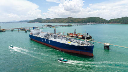 crude oil floating station in sea, bridge pipeline load unloading crude oil from oil ship transport, industry business transportation by container ship open sea, front view