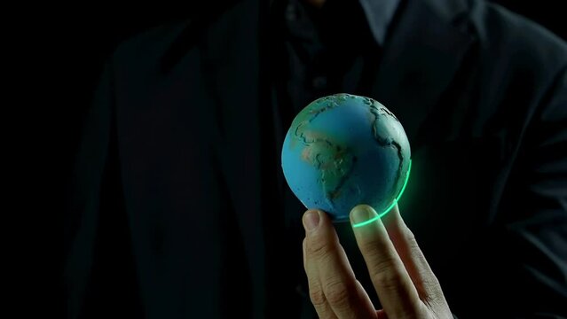 Businessman shows virtual leaf icon glowing on globe. Net zero greenhouse gas emissions target. Climate neutral long term strategy. Ecological, renewable energy and save environment concept.