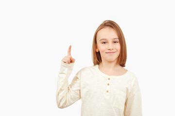 Guy pointing up at empty space. Boy gesturing new idea. Emotional portrait of happy teen boy over white background with copy space.