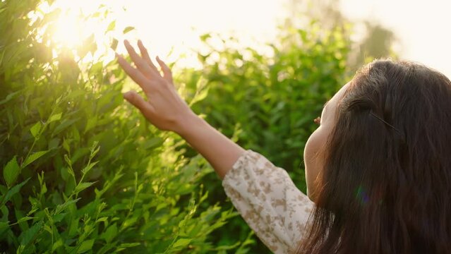 Young adult Asian woman enjoying nature at sunrise