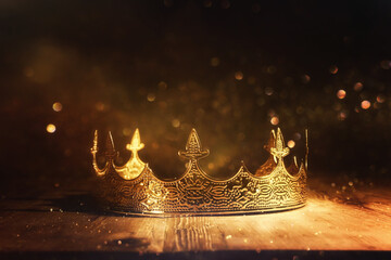 low key image of beautiful queen or king crown over wooden table. vintage filtered. fantasy...