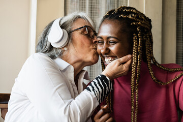 Multi generational women having tender moment at home - Care giver enjoying time with elderly senior female