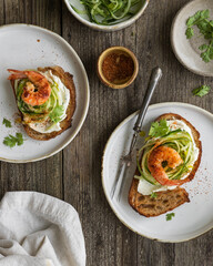 sandwich with shrimp and vegetables on a wooden table