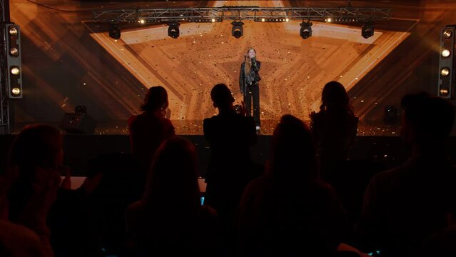 Judges Press The Golden Buzzer To Send A Contestant To A Show Finale, The Lights Changing To Gold, Young Teenager Girl Singer Talent Is Happily Surprised. Television Style Broadcast Talent Show