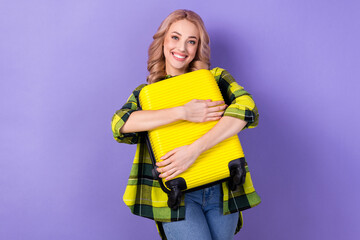 Photo of sweet shiny woman dressed checkered jacket embracing baggage isolated purple color background