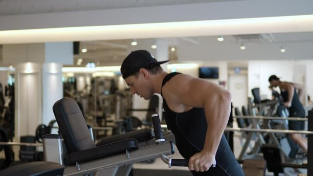 Young Male Doing Dips For Tricep Chest Muscule Training In Gym - profile view slow motion