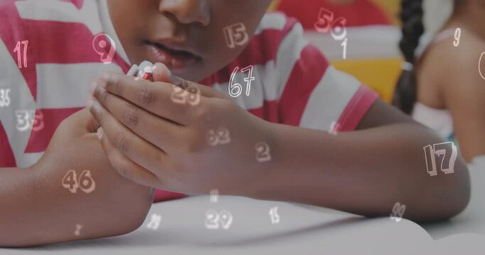 Animation of numbers over african american schoolboy writing