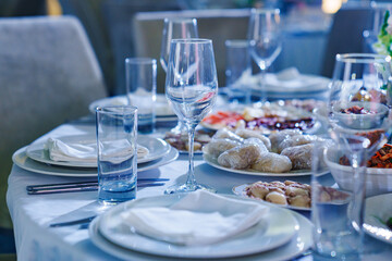 Setting the festive table. empty glasses and snacks on the table. 