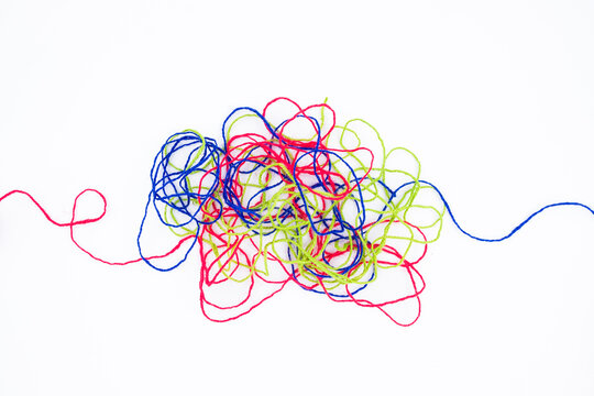 Tangled ropes on white background, three colorful ropes in confusion, psychotherapy, or difficult problem that hard to resolve