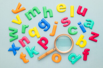 Colorful English alphabets and magnifying glass, glossary, learning English with fun