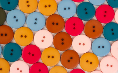 Fototapeta na wymiar Background of plastic round multi-colored buttons