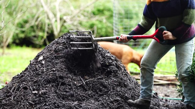 turning a Compost pile, on farm in Australia