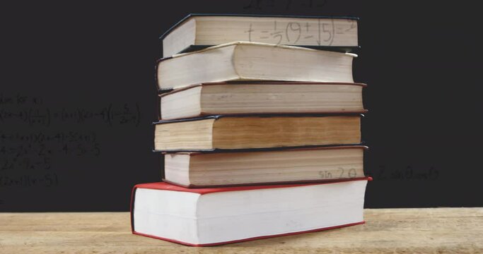 Animation of stack of books over mathematical equations and formulae