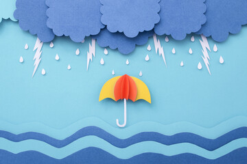 Raindrops with lightning on the sea and umbrella made of paper cut. Monsoon minimal paper art...