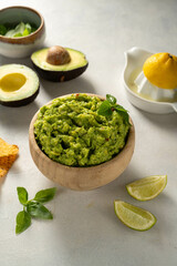 Guacamole avocado mash dip, with tortilla chips.