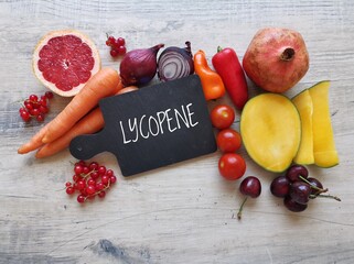 Foods rich in lycopene with text Lycopene. Natural food sources of lycopene: tomato, grapefruit,...