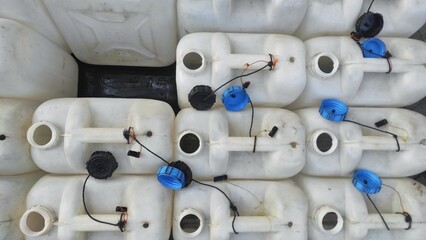 Empty white plastic gallons for distributing water in urban area