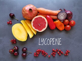 Foods rich in lycopene with text Lycopene. Natural food sources of lycopene: tomato, grapefruit, pomegranate, red bell pepper, mango, red onion, cherries and carrot. Health care concept.