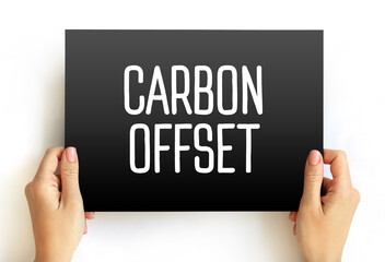 Carbon Offset - reduction of emissions of carbon dioxide made in order to compensate for emissions made elsewhere, text concept on card