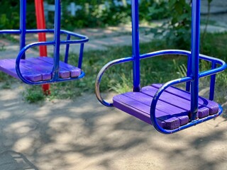 Purple liiac red swing in playground