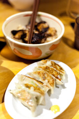 Traditional japaneese gyoza dumplings with meat and mushrooms on ceramic plate
