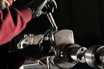 Master makes metal hardness measurement. Crankshaft.
