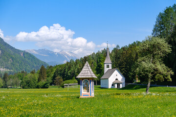 Fototapeta na wymiar Mojstrana church and sign in Slovenia