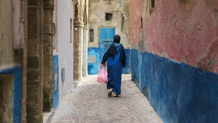 Morocco. Arab Woman walks in alley