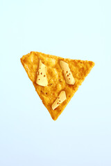 Surrealism in food. Creative poster for cheese flavored nachos chips. Blue background