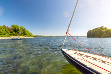 Sailboat anchoring in beautiful bay between small islands (Store Okseø or Ochseninsel) in the Baltic Sea