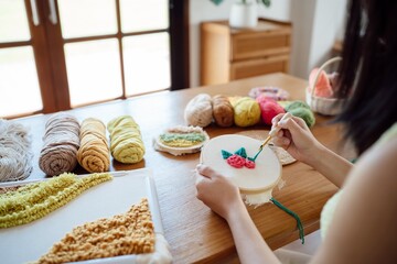 Punch needle. Asian Woman making handmade Hobby knitting in studio workshop. designer workplace...