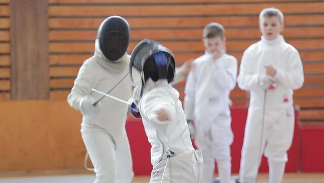 Russia St. Petersburg 01/05/2023 two children fencing on foil in a sports club